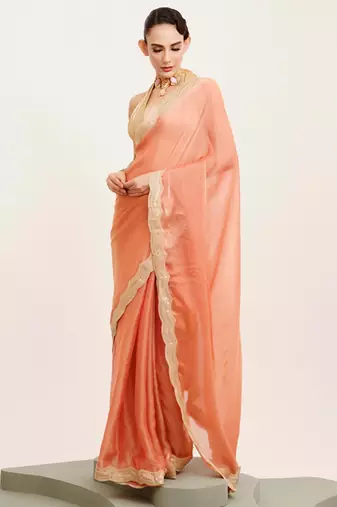 Peach solid satin saree with embellished border