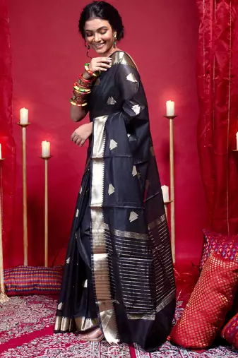 Banarasi kora organza saree in black color with triangle zari motifs and border