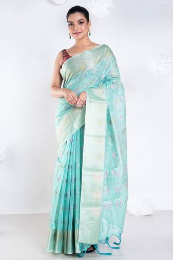 Banrasi kora organza saree in green color with multicolor abstract motifs and zari border