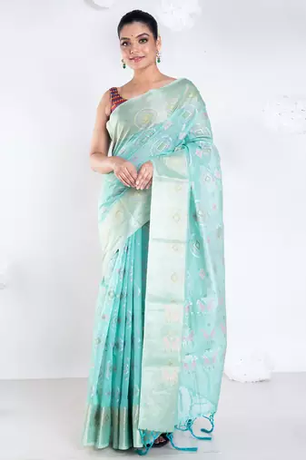 Banrasi kora organza saree in green color with multicolor abstract motifs and zari border