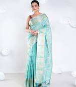 Banrasi kora organza saree in green color with multicolor abstract motifs and zari border