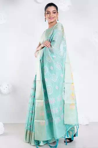 Banrasi kora organza saree in green color with multicolor abstract motifs and zari border