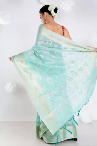 Banrasi kora organza saree in green color with multicolor abstract motifs and zari border
