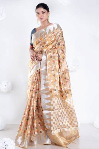 Banarasi kora organza saree in mud yellow color with multicolor motifs with copper zari
