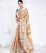 Banarasi kora organza saree in mud yellow color with multicolor motifs with copper zari