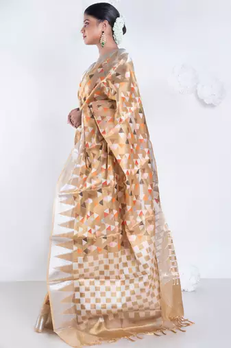 Banarasi kora organza saree in mud yellow color with multicolor motifs with copper zari