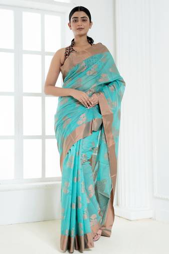 Ice blue banarasi cotton silk saree with floral motifs in antique copper gold zari