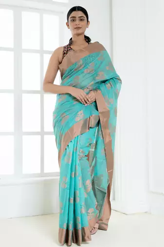 Ice blue banarasi cotton silk saree with floral motifs in antique copper gold zari