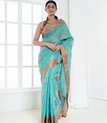 Ice blue banarasi cotton silk saree with floral motifs in antique copper gold zari
