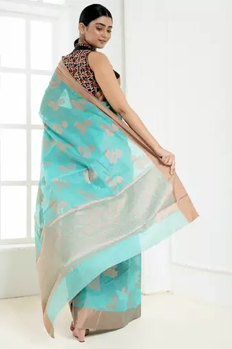 Ice blue banarasi cotton silk saree with floral motifs in antique copper gold zari