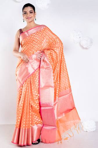 Banarasi kora organza saree in sunset orange color with golden border and booti