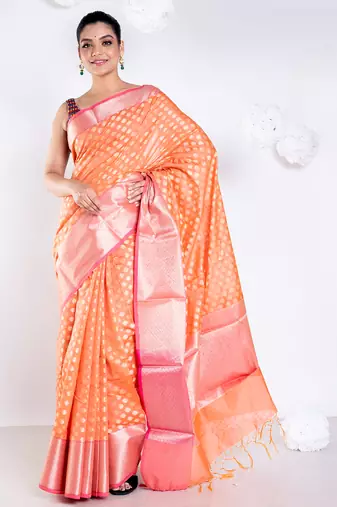 Banarasi kora organza saree in sunset orange color with golden border and booti