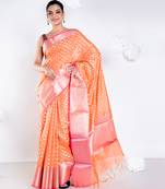 Banarasi kora organza saree in sunset orange color with golden border and booti