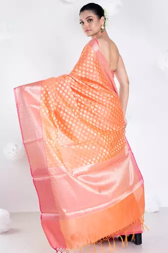 Banarasi kora organza saree in sunset orange color with golden border and booti