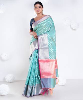 Banarasi kora organza saree in green color with golden border and booti 1