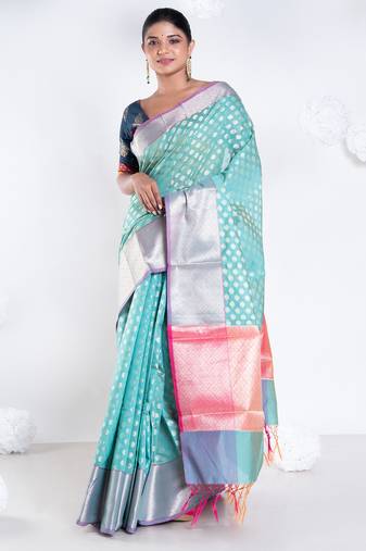 Banarasi kora organza saree in green color with golden border and booti