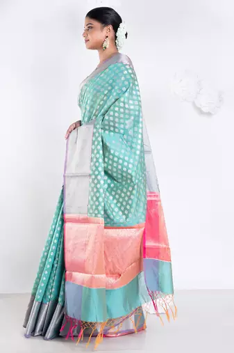 Banarasi kora organza saree in green color with golden border and booti