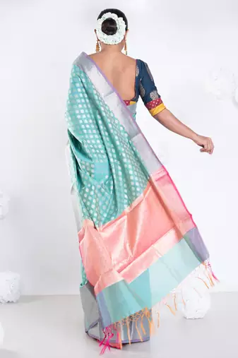 Banarasi kora organza saree in green color with golden border and booti