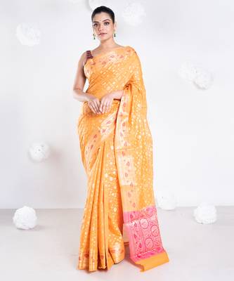 Banarasi kora organza saree in orange color with golden booti and border 1