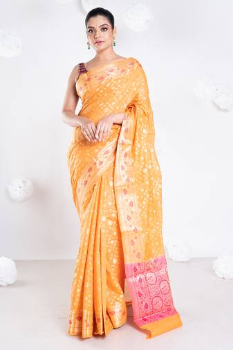 Banarasi kora organza saree in orange color with golden booti and border