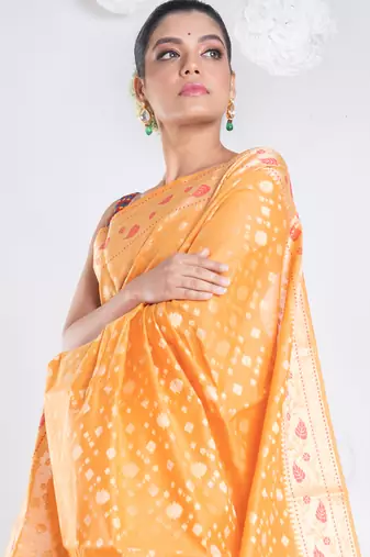 Banarasi kora organza saree in orange color with golden booti and border