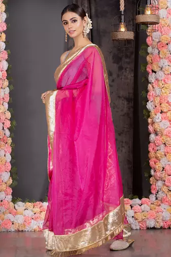 Hot pink organza saree with gold gota border and fringe lace