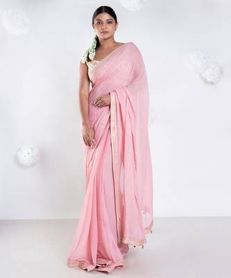 Pink color Georgette saree with golden embroidered border 1