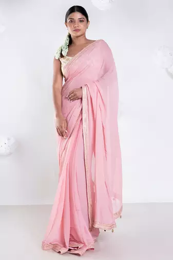 Pink color Georgette saree with golden embroidered border