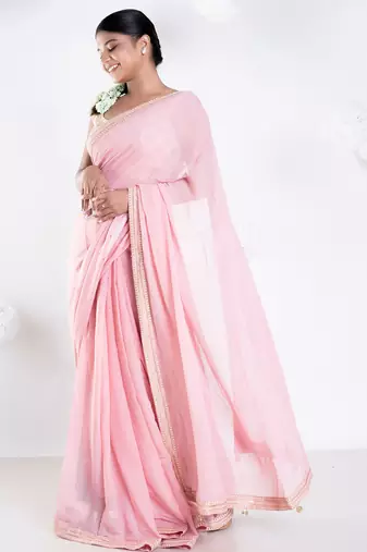 Pink color Georgette saree with golden embroidered border