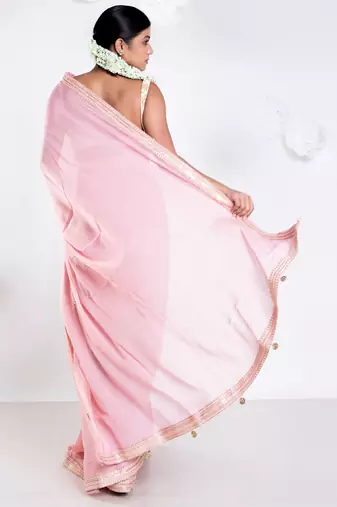 Pink color Georgette saree with golden embroidered border