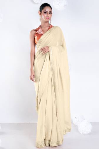 Beige color Georgette saree with golden embroidered border