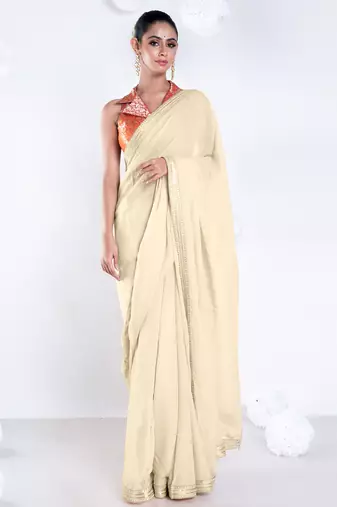 Beige color Georgette saree with golden embroidered border