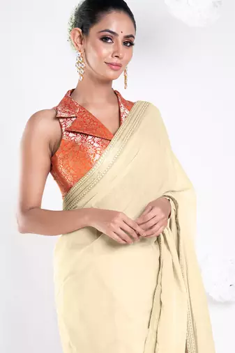 Beige color Georgette saree with golden embroidered border