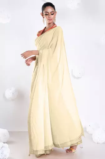 Beige color Georgette saree with golden embroidered border