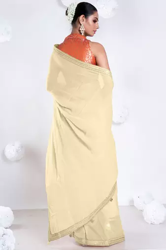 Beige color Georgette saree with golden embroidered border