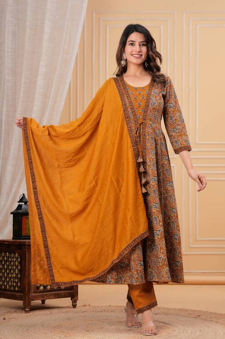 mustard yellow paisley printed anarkali kurta set with trousers and a dupatta.