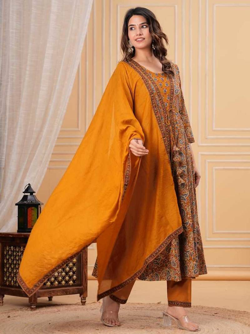 mustard yellow paisley printed anarkali kurta set with trousers and a dupatta.