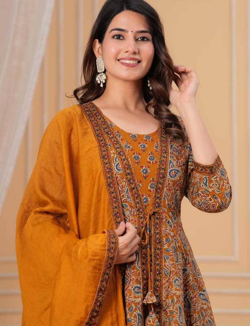 mustard yellow paisley printed anarkali kurta set with trousers and a dupatta.