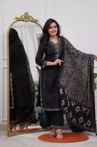 black cotton kurta, pants, and a printed dupatta set.