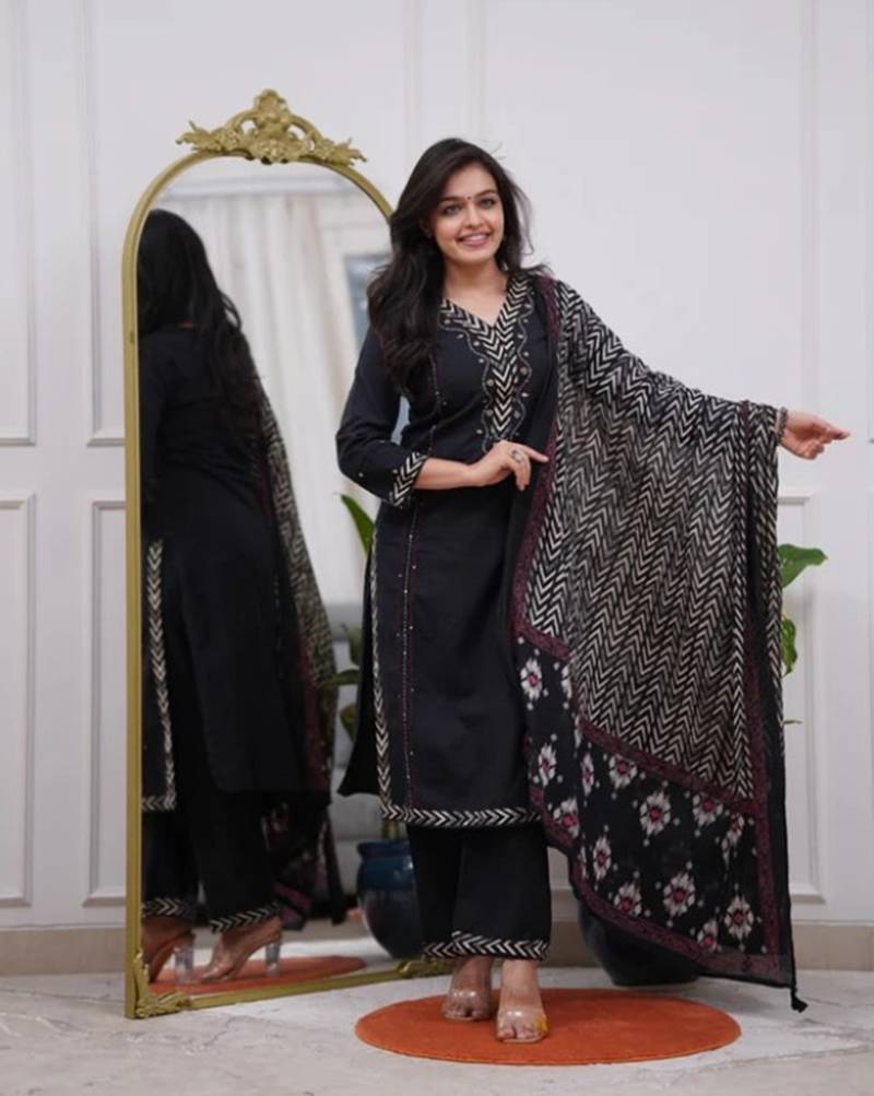 black cotton kurta, pants, and a printed dupatta set.