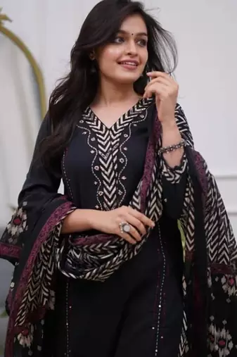 black cotton kurta, pants, and a printed dupatta set.