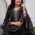 black cotton kurta, pants, and a printed dupatta set.