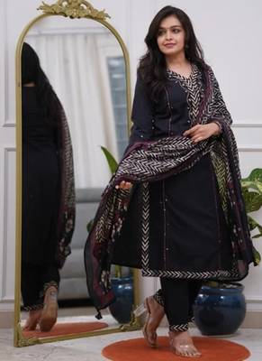 black cotton kurta, pants, and a printed dupatta set. 3