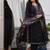 black cotton kurta, pants, and a printed dupatta set.
