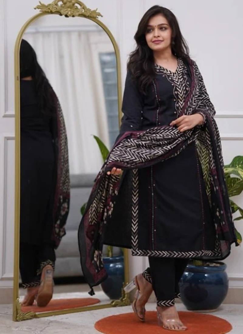 black cotton kurta, pants, and a printed dupatta set.