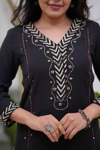 black cotton kurta, pants, and a printed dupatta set.