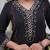 black cotton kurta, pants, and a printed dupatta set.