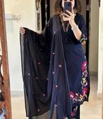 black salwar kameez suit with red and green floral embroidery.