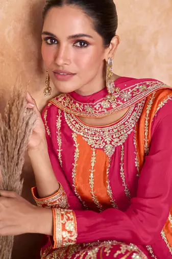 Pink-orange chinon straight long top palazzo suit with heavy gold zari, resham thread & sequins, free-size stitched.