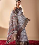 grey soft lichi silk blend sea green saree with abstract floral print & golden zari border
